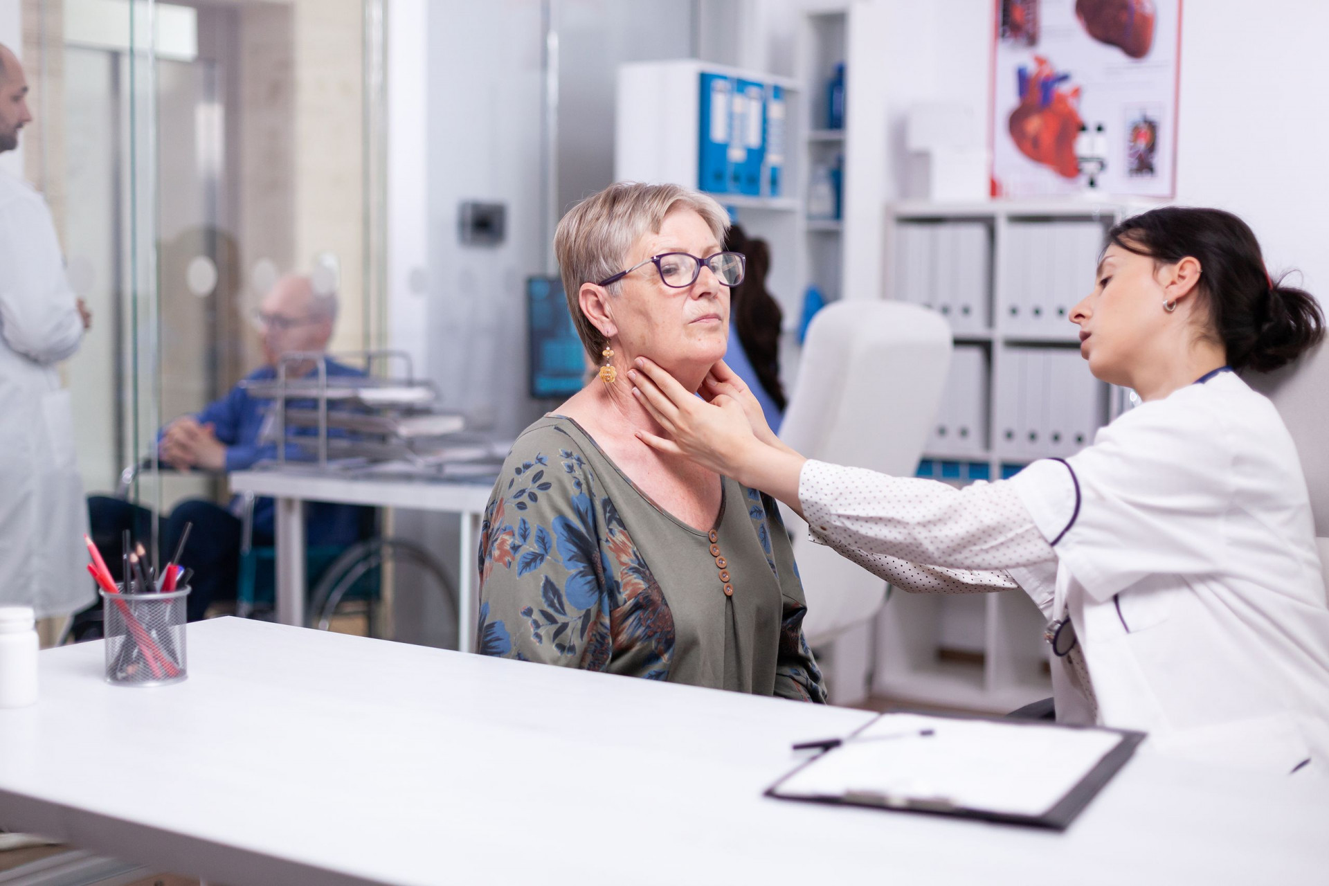 Professional Physician Checking Neck Lymph Nodes Of Old Woman, Palpating Senior Woman. Elderly Patie