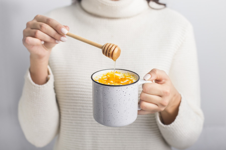 Woman Drinking Golden Turmeric Milk With Honey