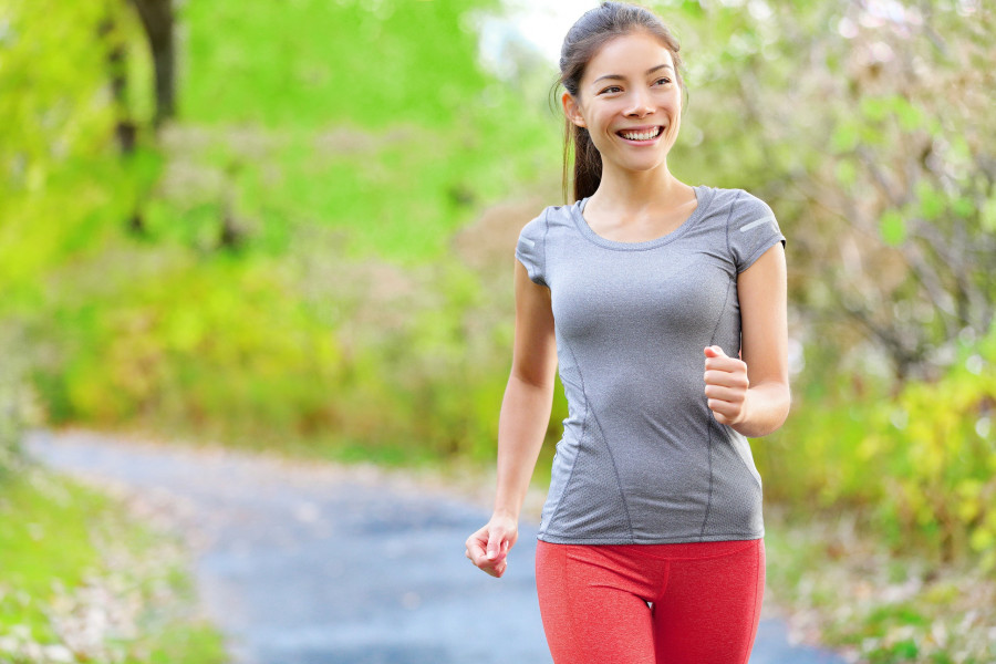 Woman walking, jogging and running lightly in forest