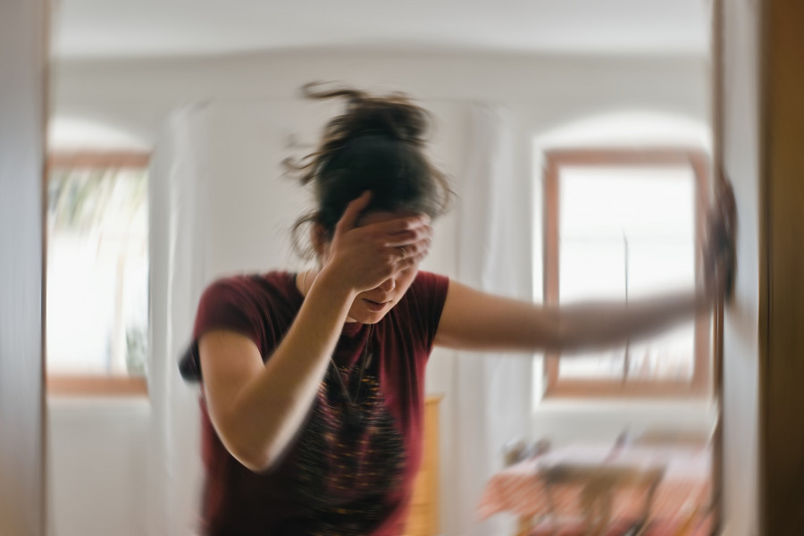 Woman Suffering From Vertigo Or Dizziness