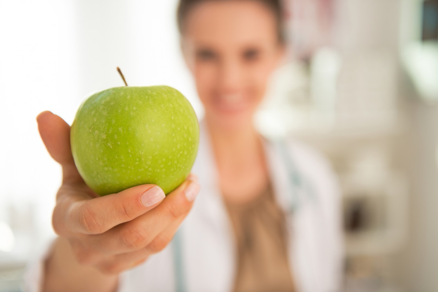 Doctor Woman Giving Apple