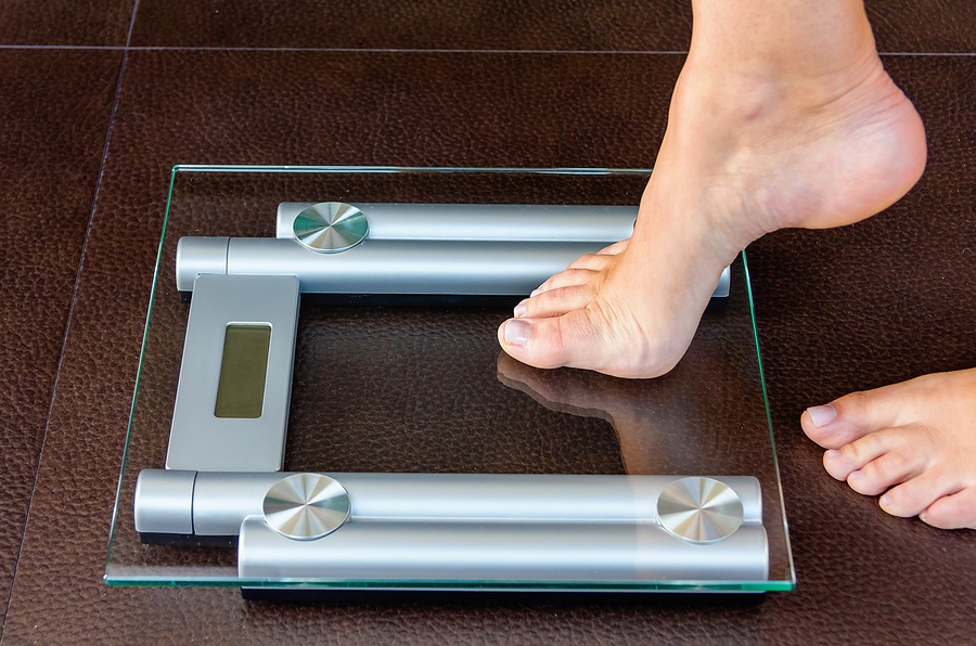 woman foot uploading to bathroom scale