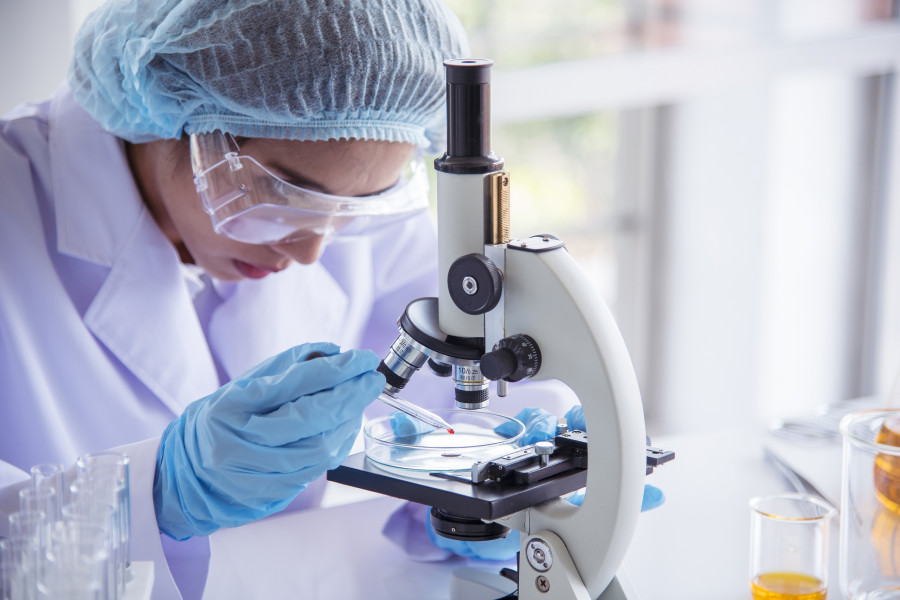Woman Scientist In Lab Look At Science Microscope