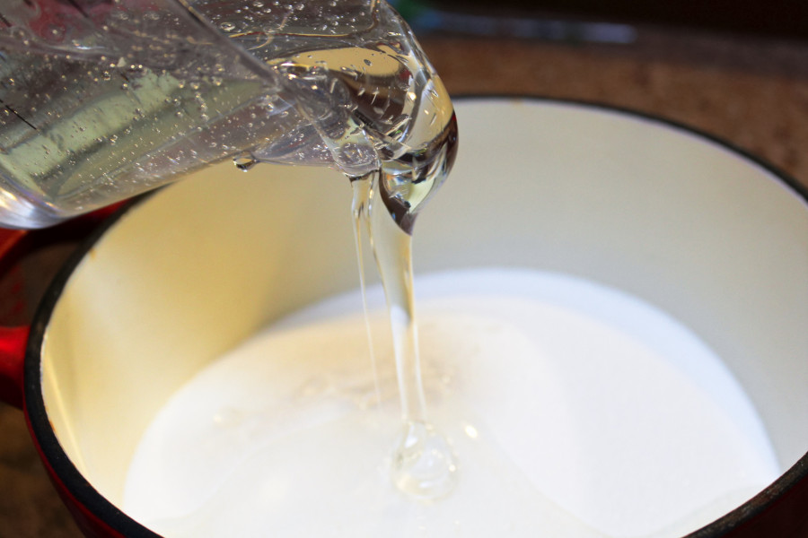 Pouring Corn Syrup Into A Pot To Make Hard Candy