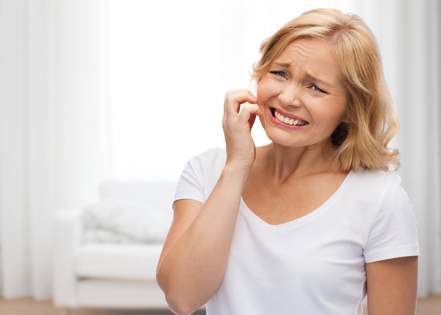 unhappy woman suffering from face inch