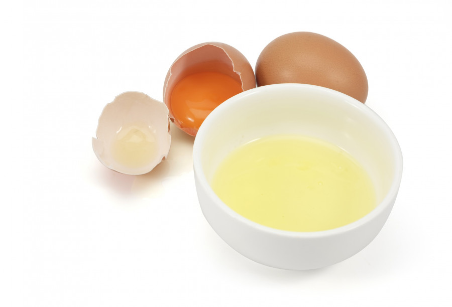 White Egg In The Cup And Egg Yolk In A Eggshell