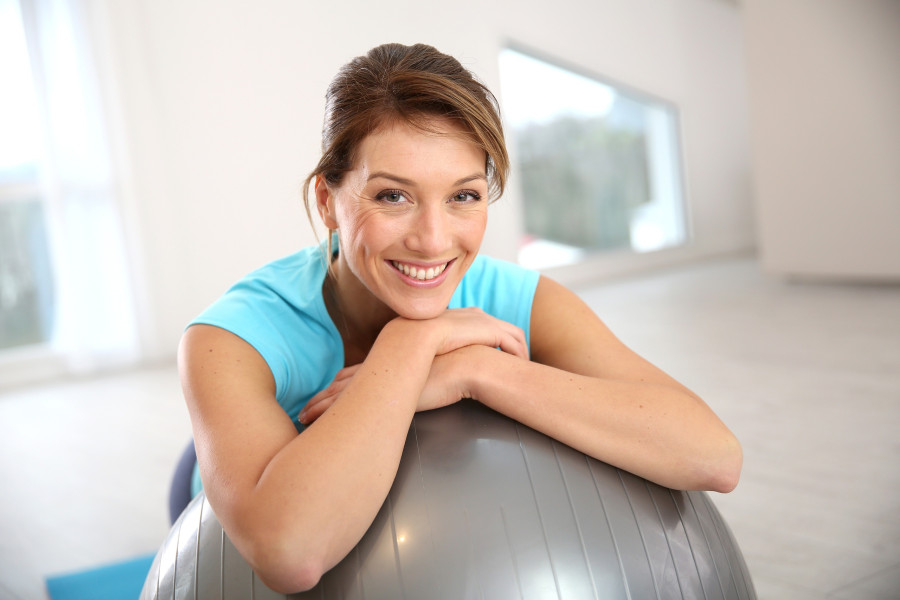 Woman doing pilates and balance exercises