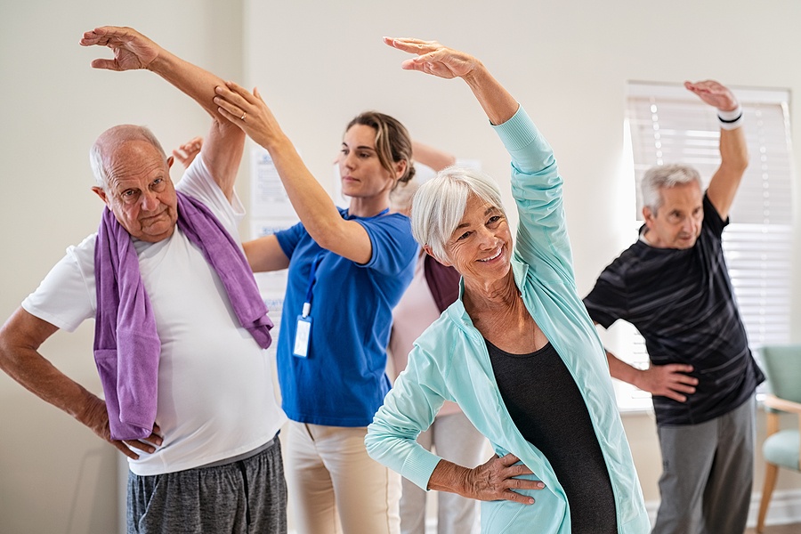 Active seniors doing exercise with physiotherapist