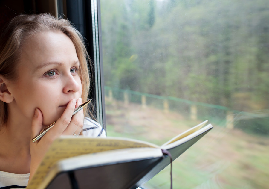 woman on a train writing notes