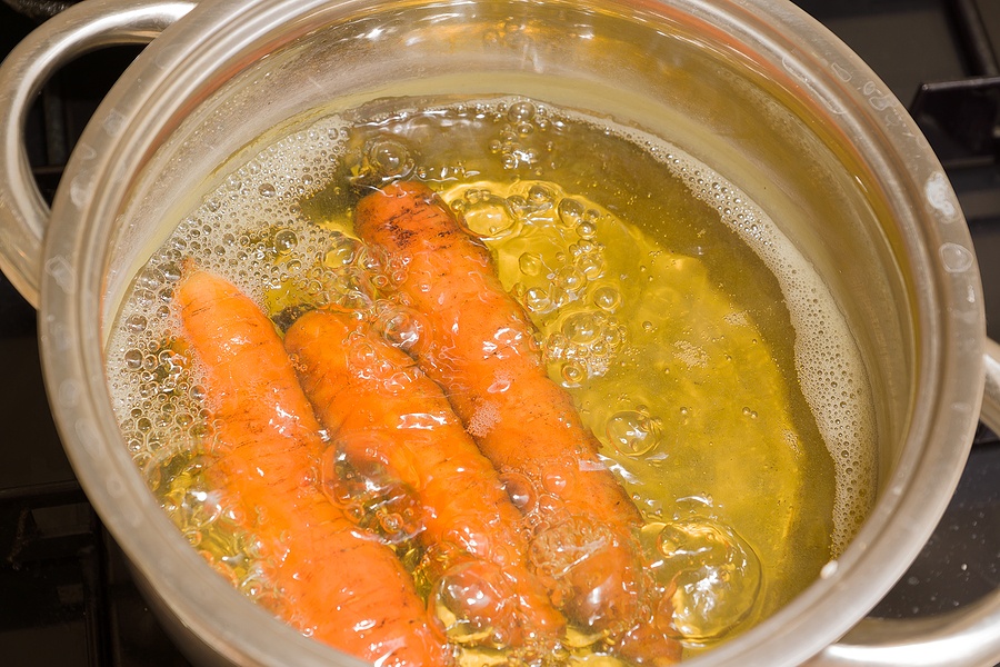Raw Carrots Are Boiled In A Pot Of Boiling Water