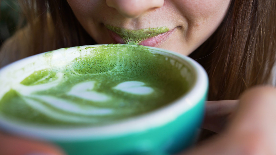 Woman Drinks Matcha Latte