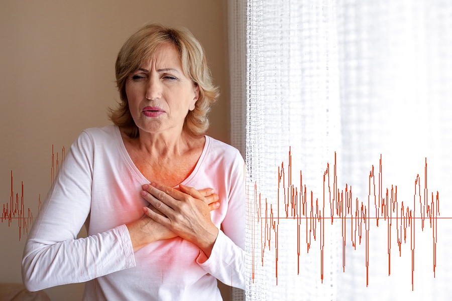 woman suffering from heart attack at home