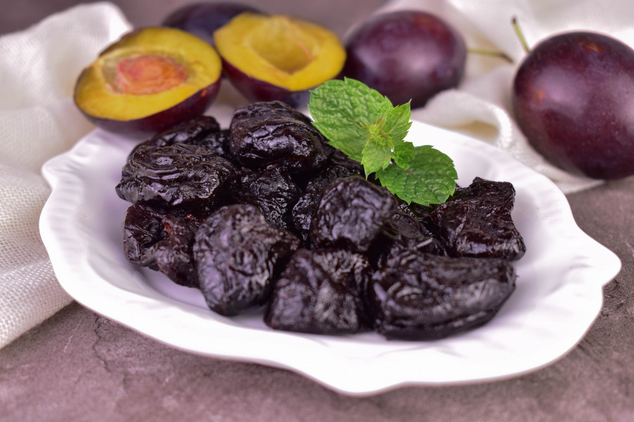 A Plate With Prunes. Close-up Of Dried Plums.