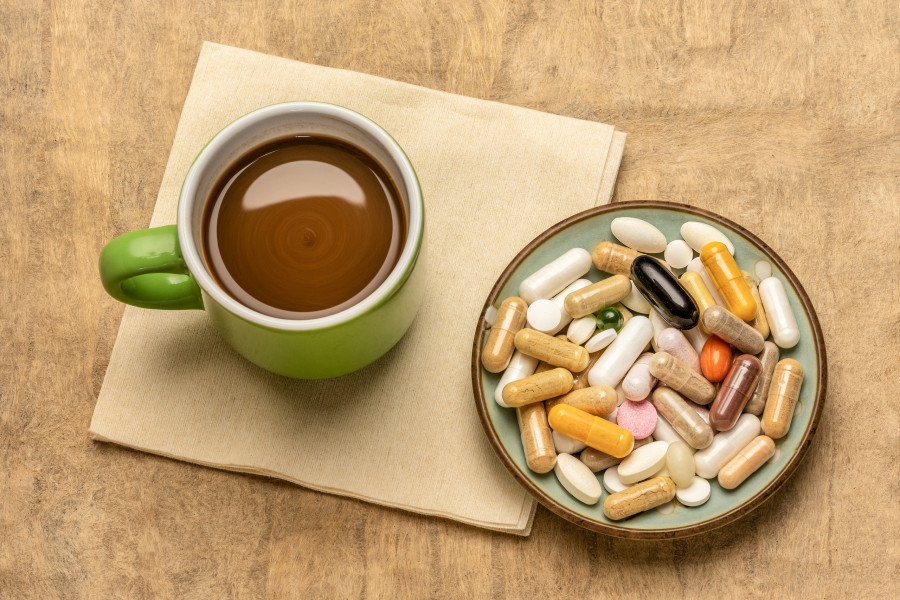 pills, capsules and tablets with a cup of coffee