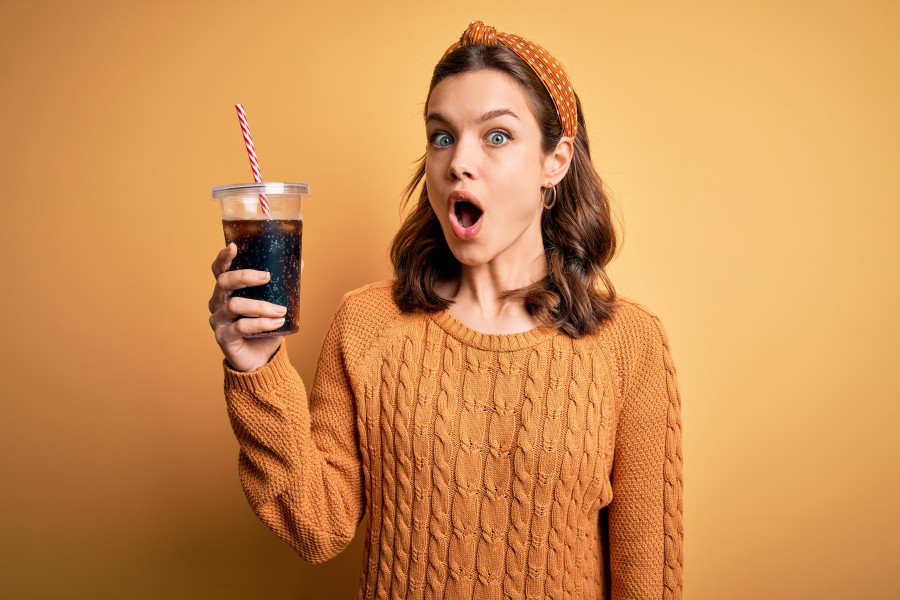 girl drinking a glass of soda