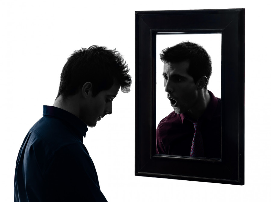 man in front of his mirror