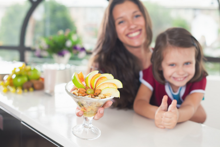 little girl cooking with her sister