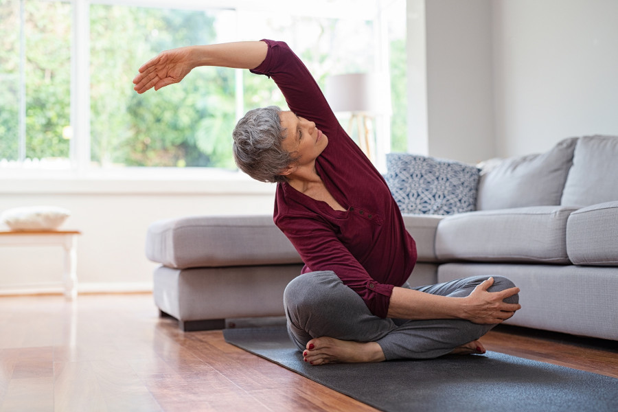 woman exercising yoga at home