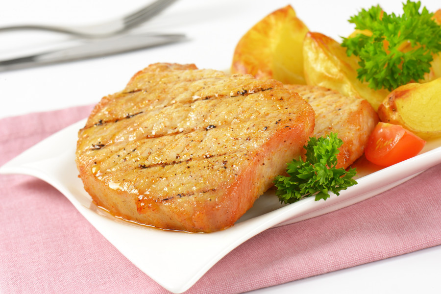 grilled slices of pork and roasted potatoes