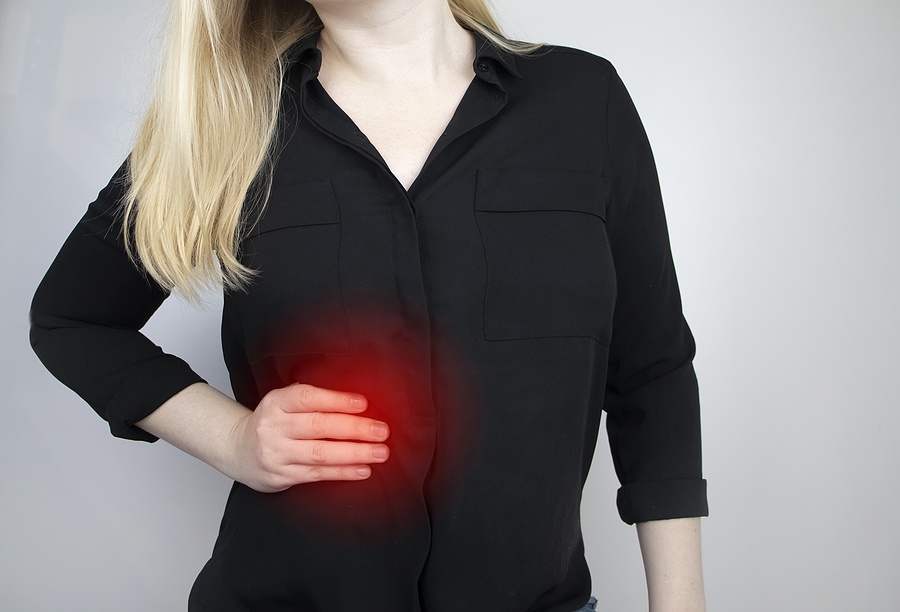 A Woman Grabs His Right Side Under The Ribs. Pain In The Liver.