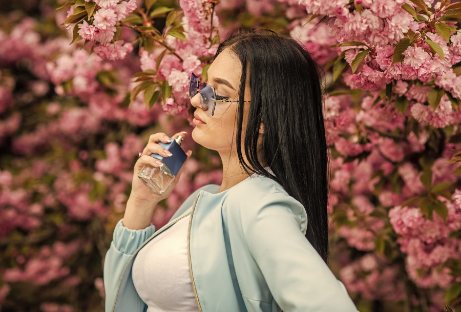 woman holds perfume bottle