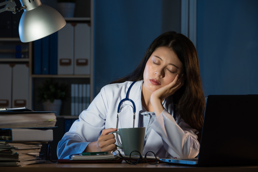 Exhausted Doctor Sleeping With Coffee