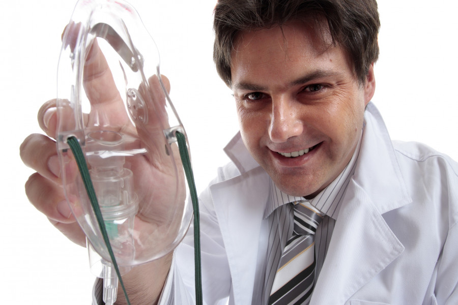 Male Doctor Or Anesthetist holding a mask