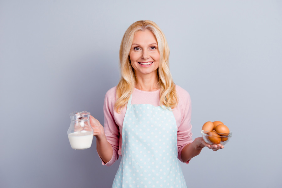 Woman In Apron holding milk and eggs