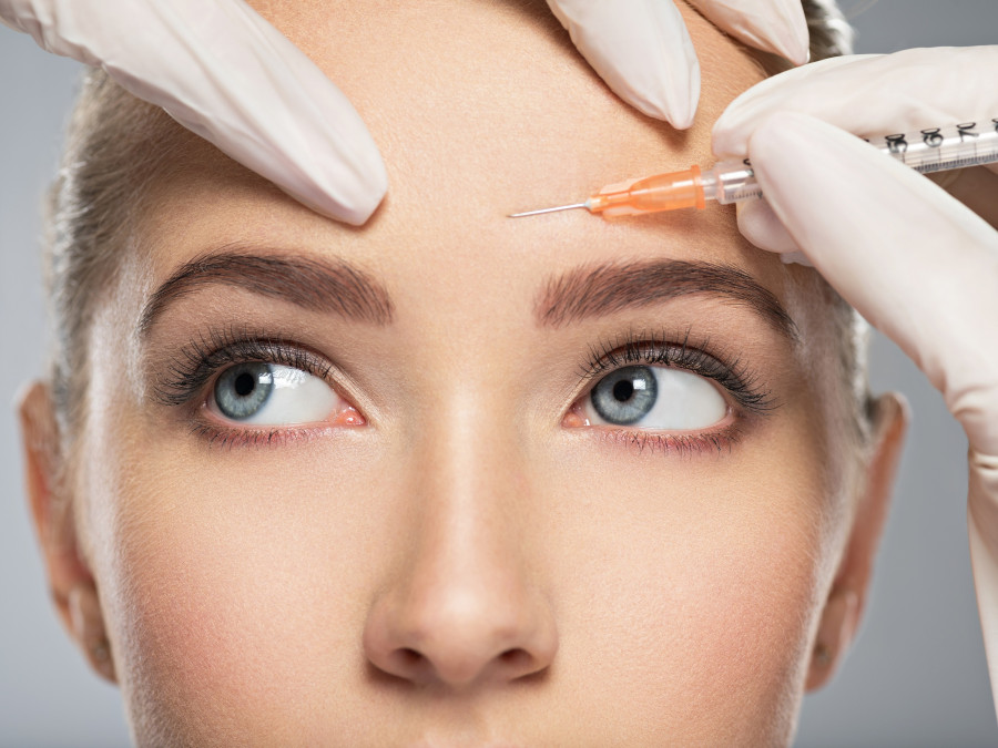 woman gets botox injection in her face