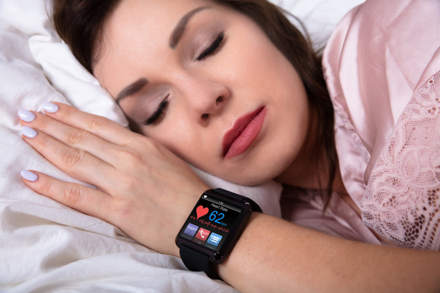 Woman Sleeping With Smartwatch Showing Heartbeat