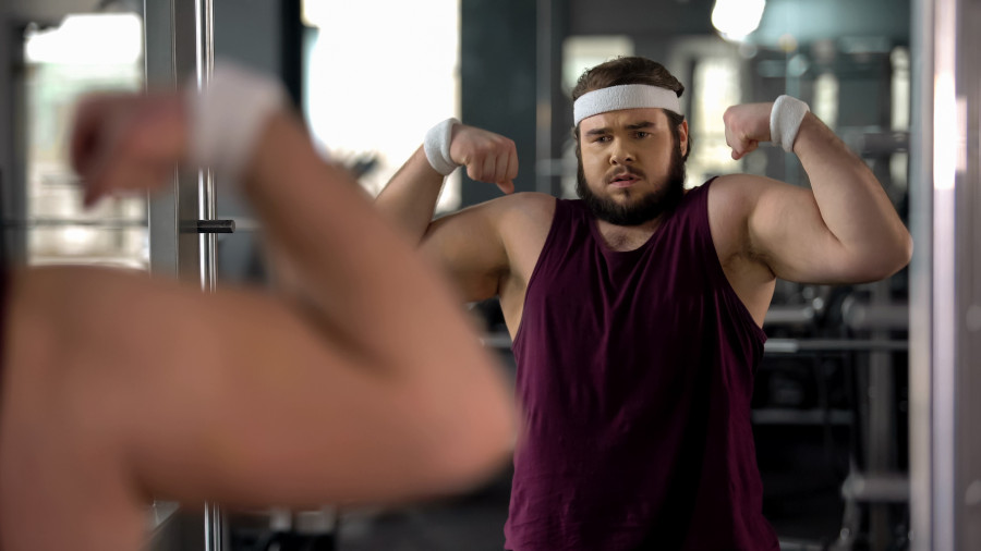 Positive Fat Man Looking At Mirror Reflection And Posing