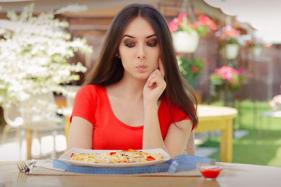 Woman Thinking About Eating Pizza on a Diet