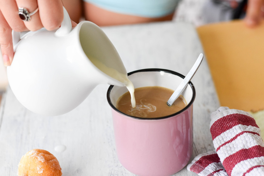 Pouring Milk Into Coffee