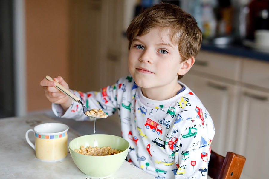 Kid Boy Eating Cereals For Breakfast