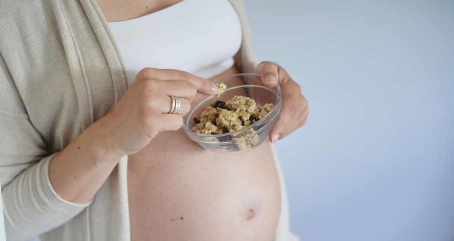 Pregnant woman eating cereals