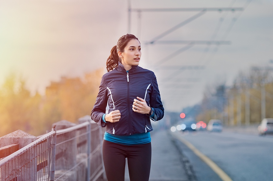woman jogging on the street early in morning