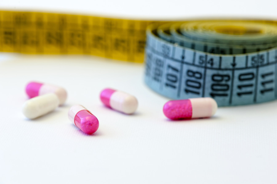Measuring tape and pills for dieting concept
