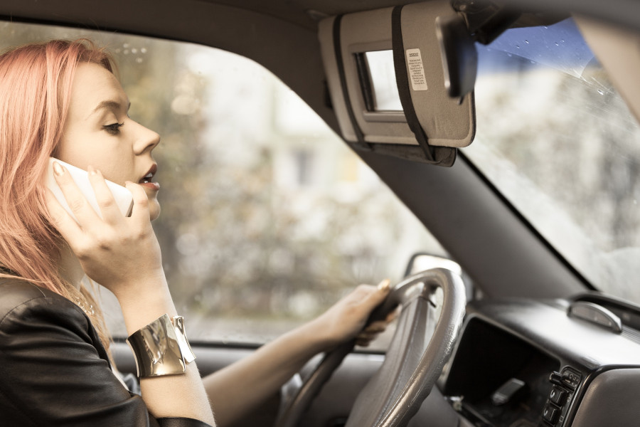 Woman Talking On Mobile Phone While Driving