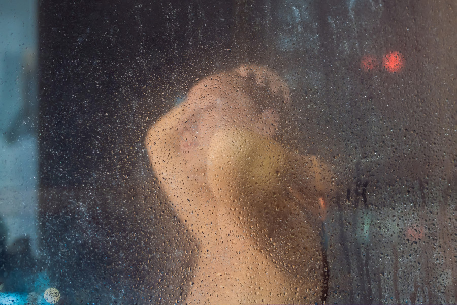 Woman In The Shower Behind Glass