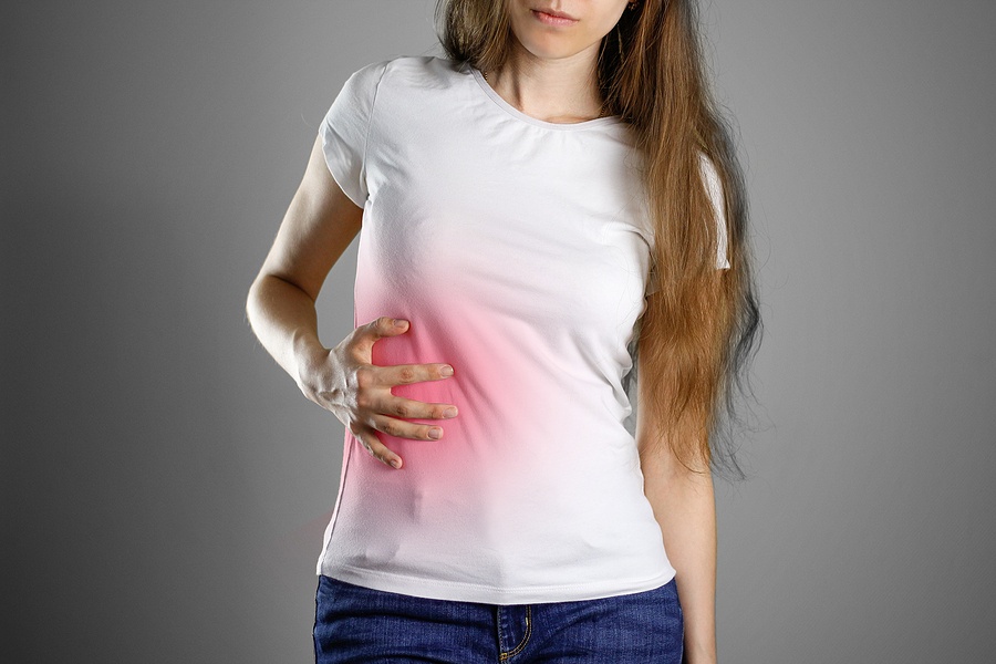 A Woman Holds The Liver. Pain In The Abdomen
