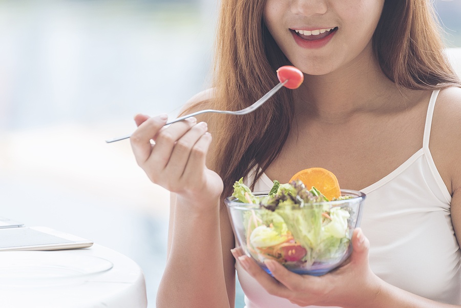 woman eating green fresh ingredients organic salad