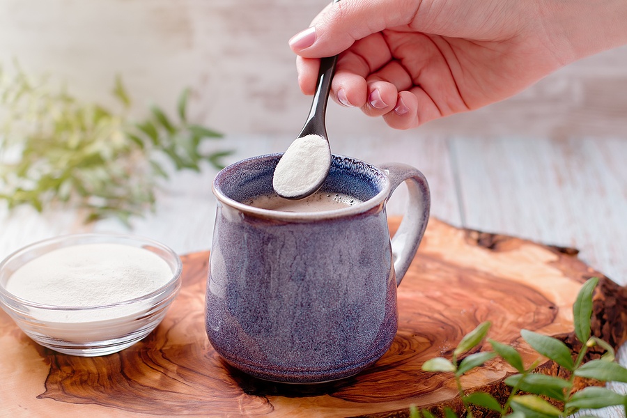 Woman Adding Collagen Powder To Her Morning Coffee