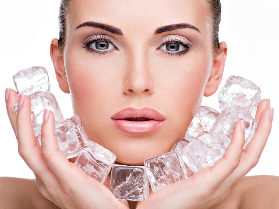 woman applies the ice to face. Skin care concept
