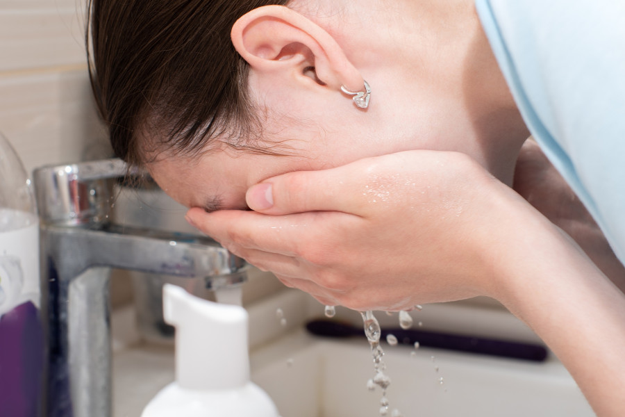 Woman Washes Face