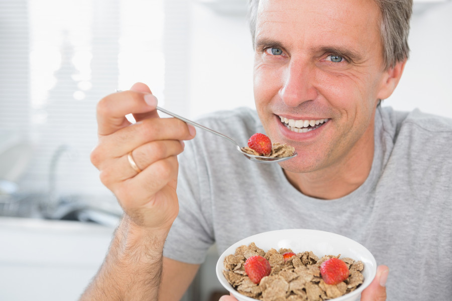 man eating cereal for breakfast