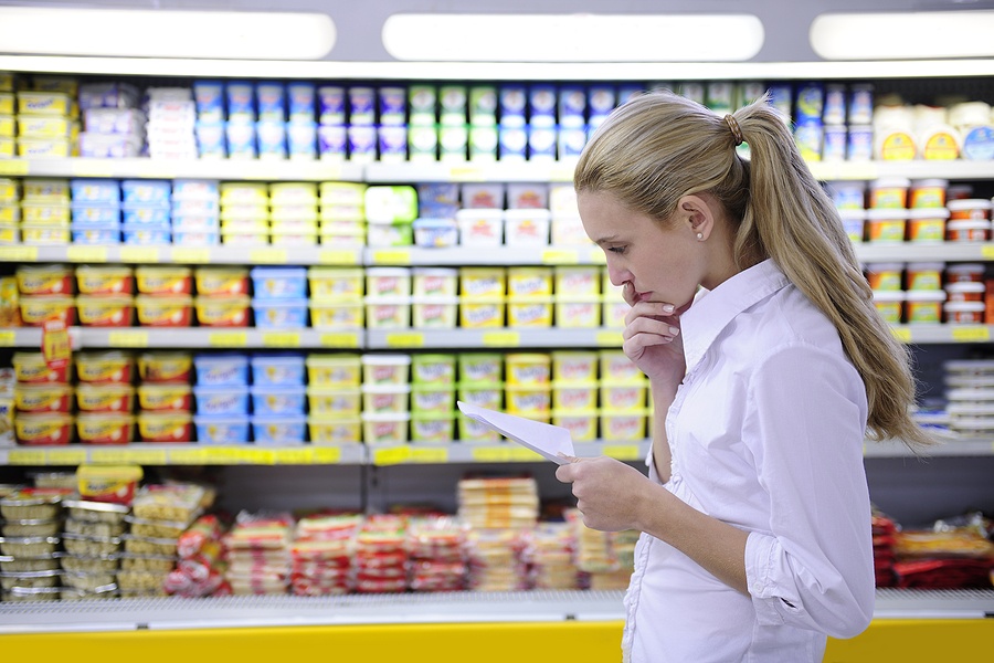 woman reading her shopping list in the supermarket