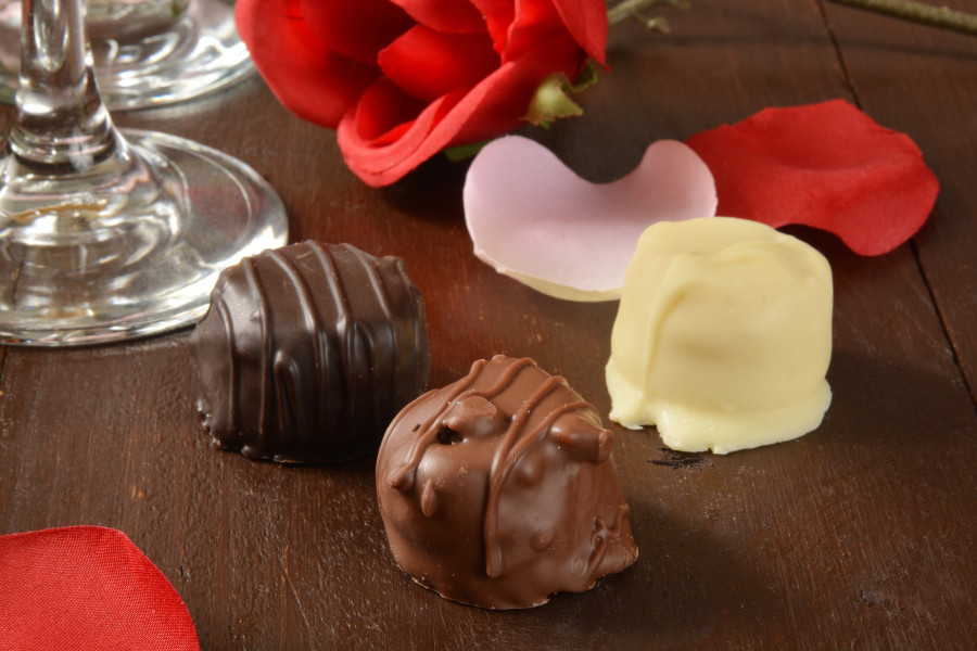 Assoted gorumet chocolates with roses and wine