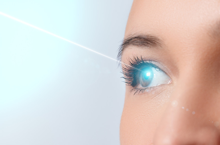Woman's Eye Close-up Laser Beam On The Cornea
